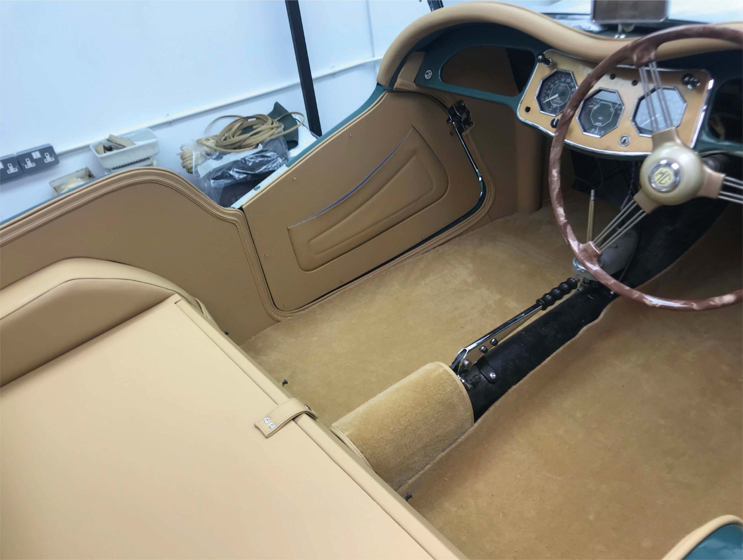 Inside of an MG car with a stripped interior